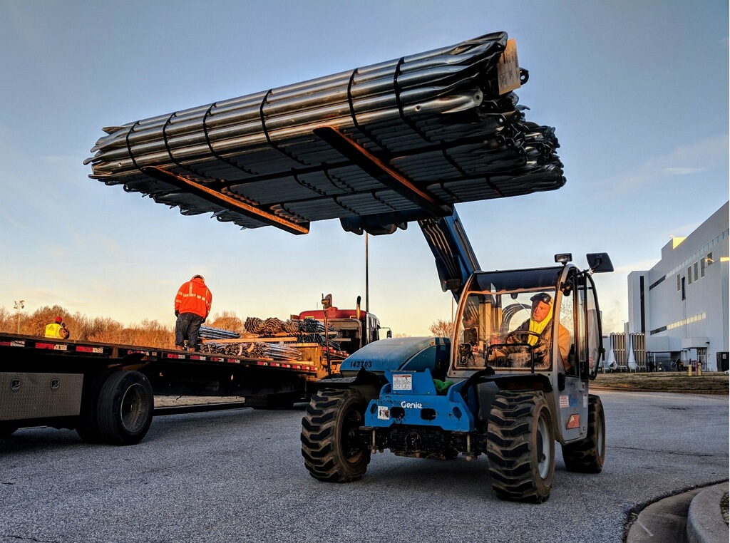 Forklift with Quest Renewables solar carport materials.